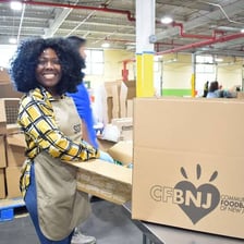 A volunteer helping people at a community food bank