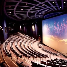A giant IMAX movie screen inside a theater