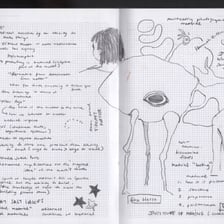 A hand quickly scribbling notes in a notebook