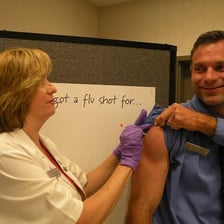 A healthcare worker administering a flu vaccination