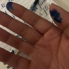 Dark ink stains spreading across a sheet of paper