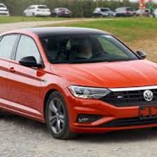 A Volkswagen Jetta parked outdoors, shown from a three-quarter front view