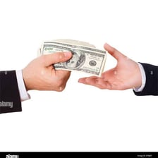A person handing cash to settle a bill