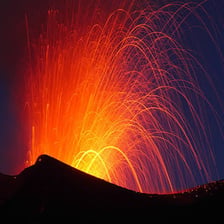 A volcano forcefully ejecting glowing lava during an eruption
