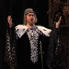 A bass opera singer performing onstage.