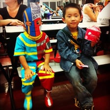 A child pretending to be a character while wearing a costume.
