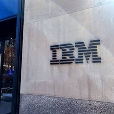 IBM’s blue striped logo displayed on a technology company building
