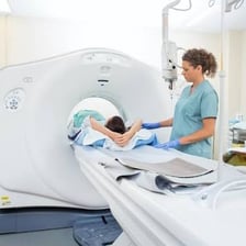 A patient lying inside the cylindrical opening of an MRI scanner