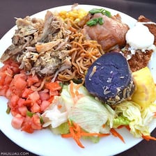 A Hawaiian luau with food and festive outdoor decorations