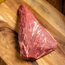 A raw triangular tri-tip steak cut
