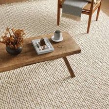 A handwoven rug displayed on a floor.