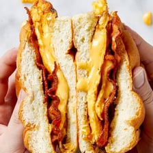 A breakfast sandwich containing bacon, egg, and cheese