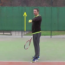 A person lightly throwing a ball.