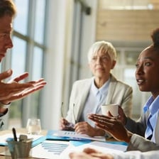 A person visibly expressing enthusiastic agreement during a conversation.