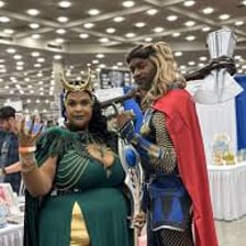 Fans in costumes at a comic and superhero convention