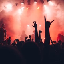 A promoter or performer energizing a crowd at a concert.