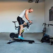 People pedaling stationary bicycles during an indoor spin class