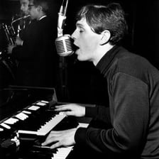Musician Elton John performing at a piano