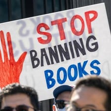 Books behind a censorship barrier at a protest