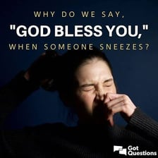 One person sneezing while another offers a polite response