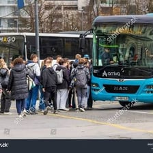 A city bus stopped while a passenger boards.