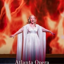 A glamorous singer performing dramatically on a stage