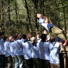 A group catching a participant during a trust fall exercise
