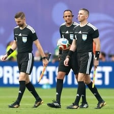 A soccer referee officiating a match.