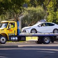 A roadside-assistance tow truck helping a stranded car