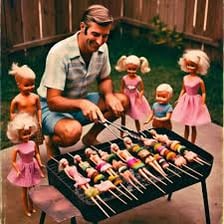 A Barbie doll shown near an outdoor barbecue grill.