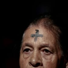 A person receiving ashes on the forehead for Ash Wednesday