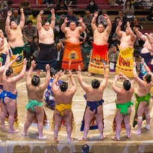 Sumo wrestlers facing each other in a traditional ring