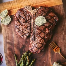 A grilled T-bone steak showing its T-shaped bone