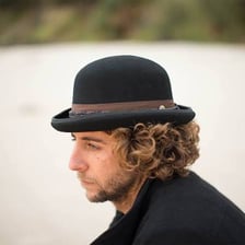 A horse race associated with the word derby alongside a classic derby hat
