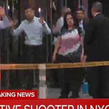 A person being escorted out of a building