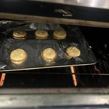 A tray of cookies baking in an oven
