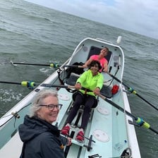 A rower holding an oar in a boat