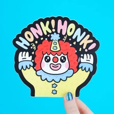 Clowns crowded inside a small clown car, including one with a honking nose