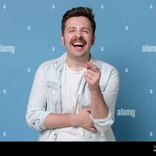 A person reacting with amusement to something funny