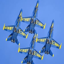 Blue Angels jets flying in a precision formation.