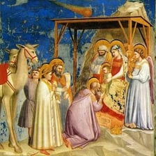 The three Magi presenting gifts in a nativity scene