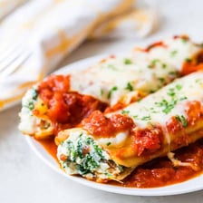 Baked manicotti pasta tubes filled with ricotta cheese