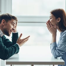 Two people conversing as one person realizes the point being explained.