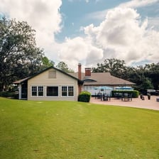 A clubhouse and golf course at a country club