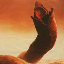 A giant sandworm emerging from the desert in a Dune-inspired scene