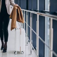 A traveler arriving at a destination while carrying luggage