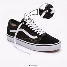 A shoelace threaded through the eyelets of a sneaker