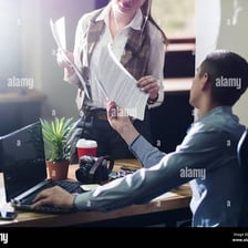 An assistant helping a coworker in an office