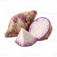 A taro root cut open to reveal purple flecks in its pale flesh