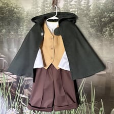 A fantasy costume featuring a long brown cloak.